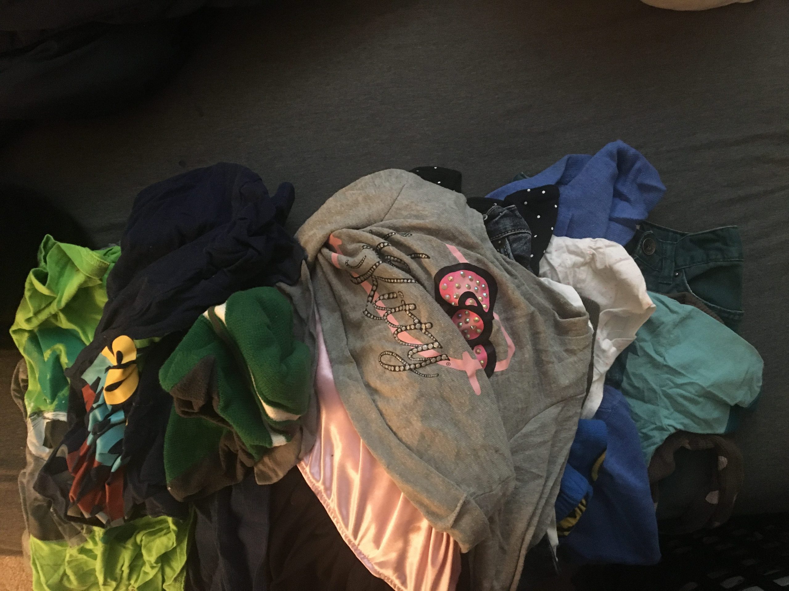 A pile of clothes on a bed